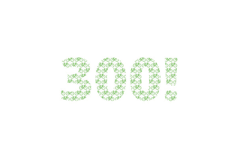Green bicycle icons spelling out '300!' on a white background