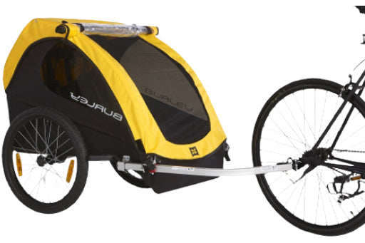 Yellow and black bicycle trailer with a bike attached on a white background
