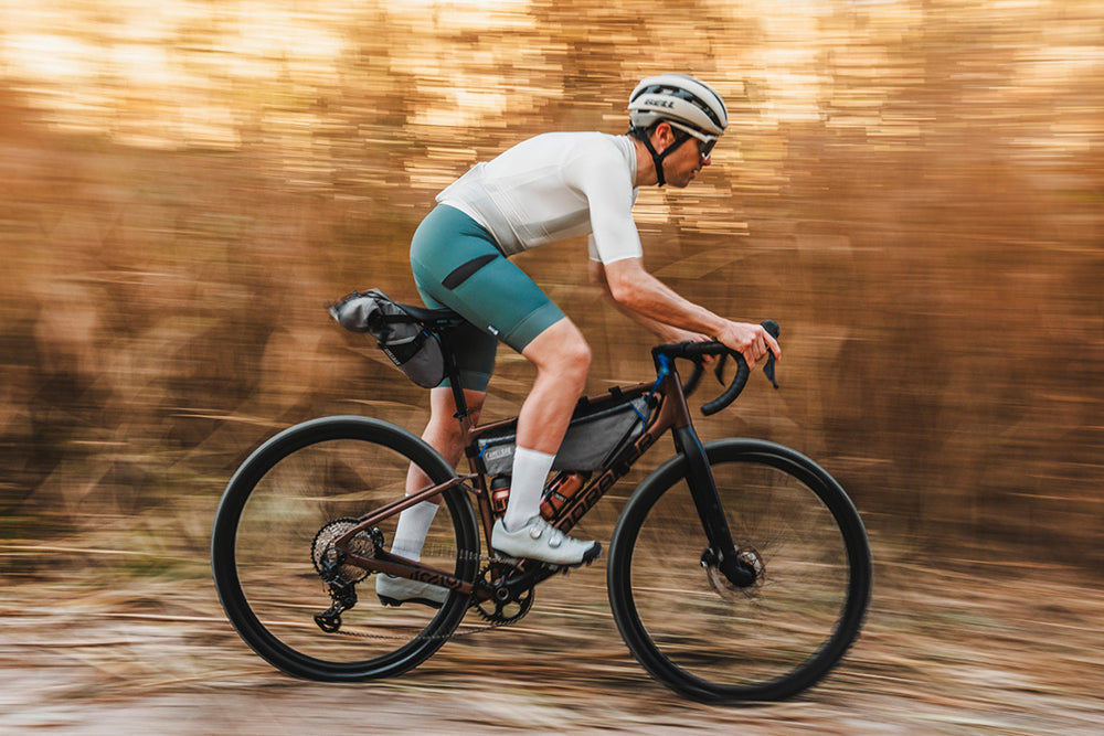 Person riding a bicycle on a blurred natural background