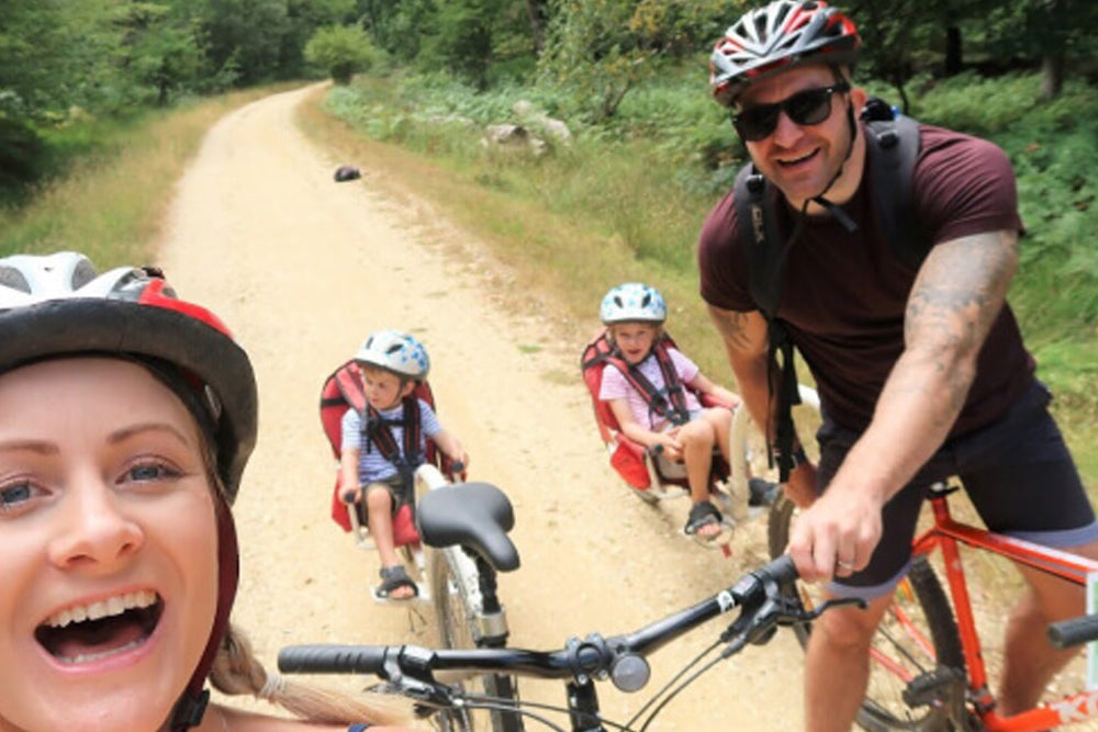 Family of four on bicycles in a natural setting