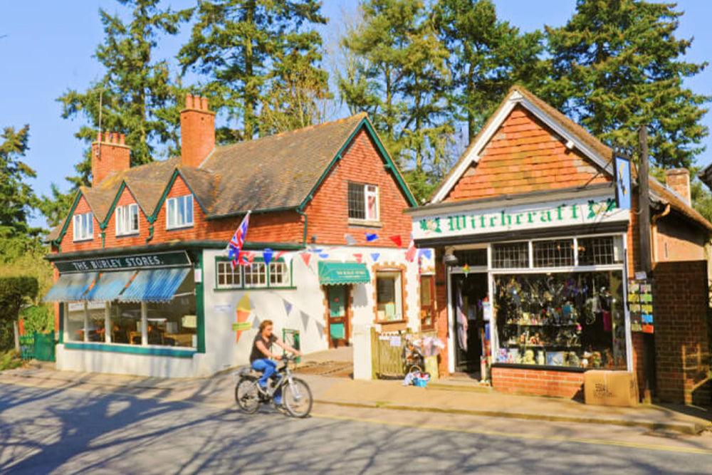 Small town street with shops and a person on a bike