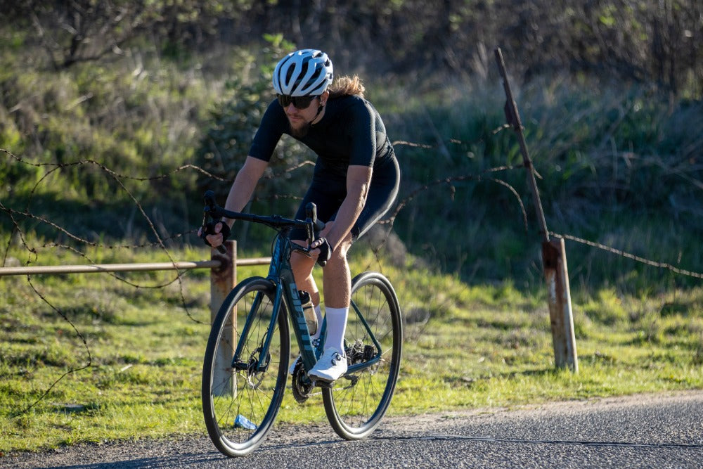 Man riding on a country road on a carbon road bike
