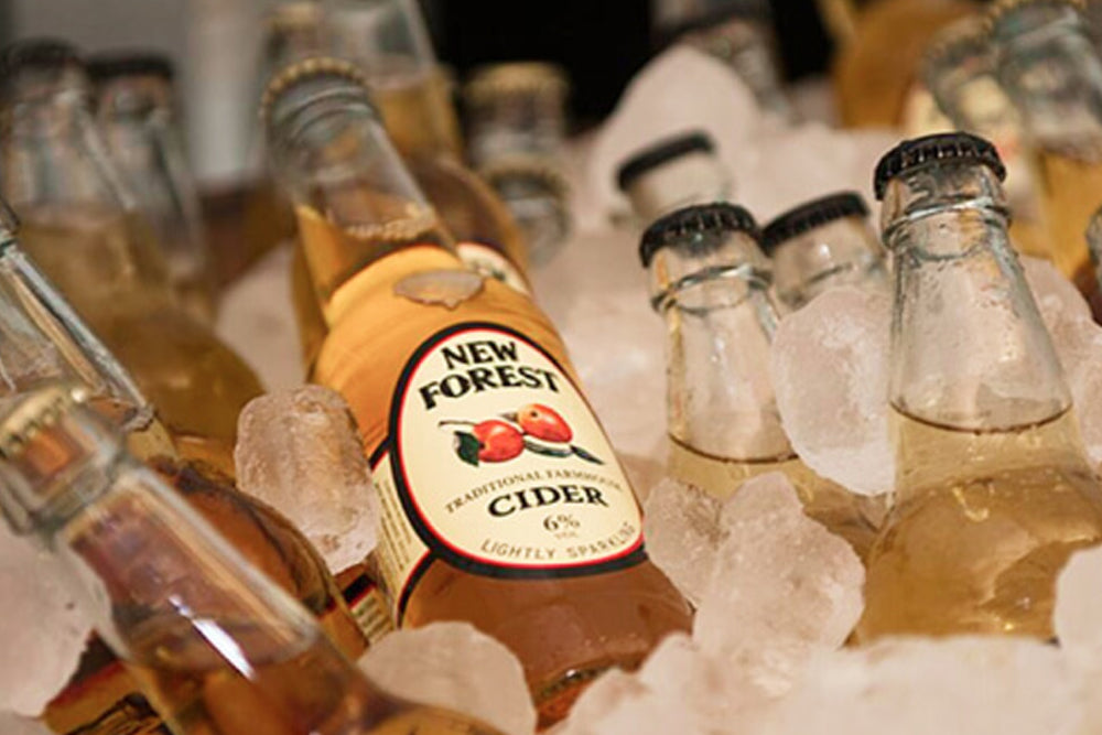 Bottles of New Forest cider on ice with a blurred background
