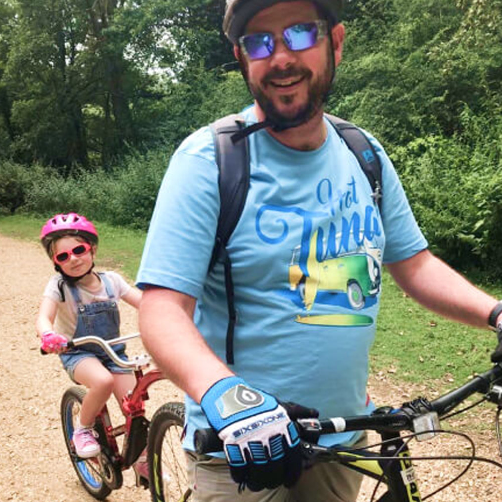 Man and child on bikes in a park setting