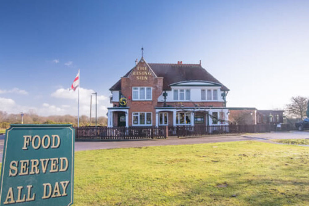 Image of the Rising Sun pub on a sunny day