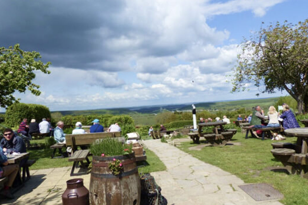 Beer garden overlooking countryside scenery on a cloudy day