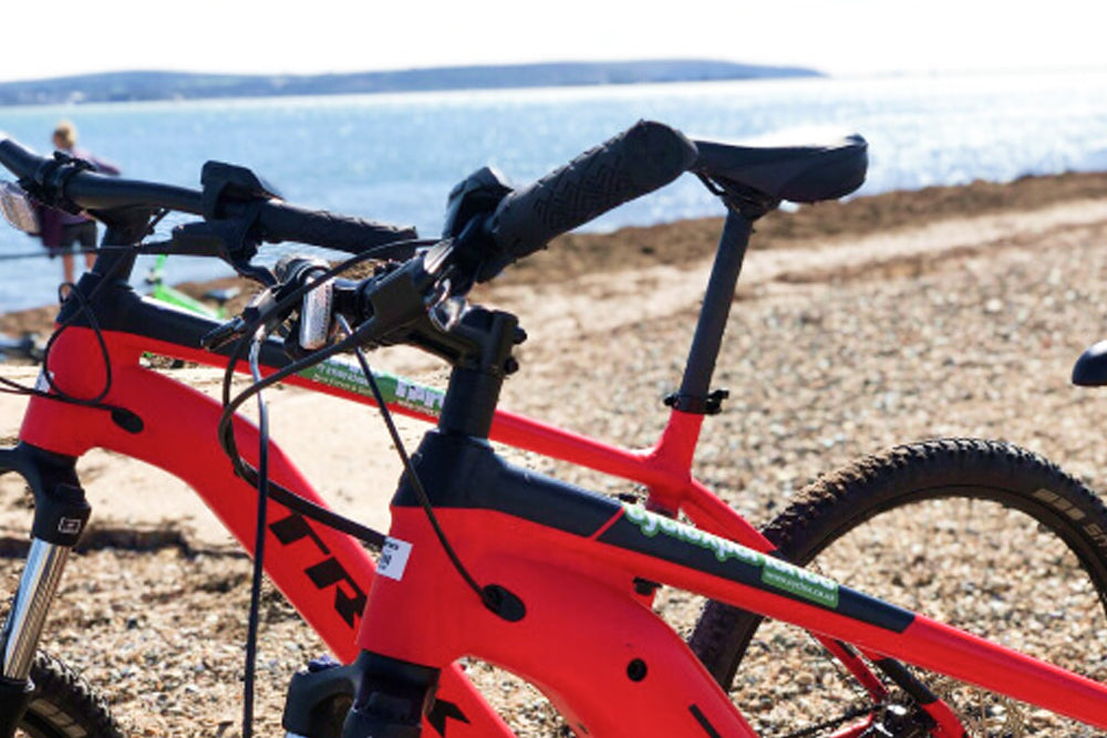 Red bicycle on a gravel path with a scenic background