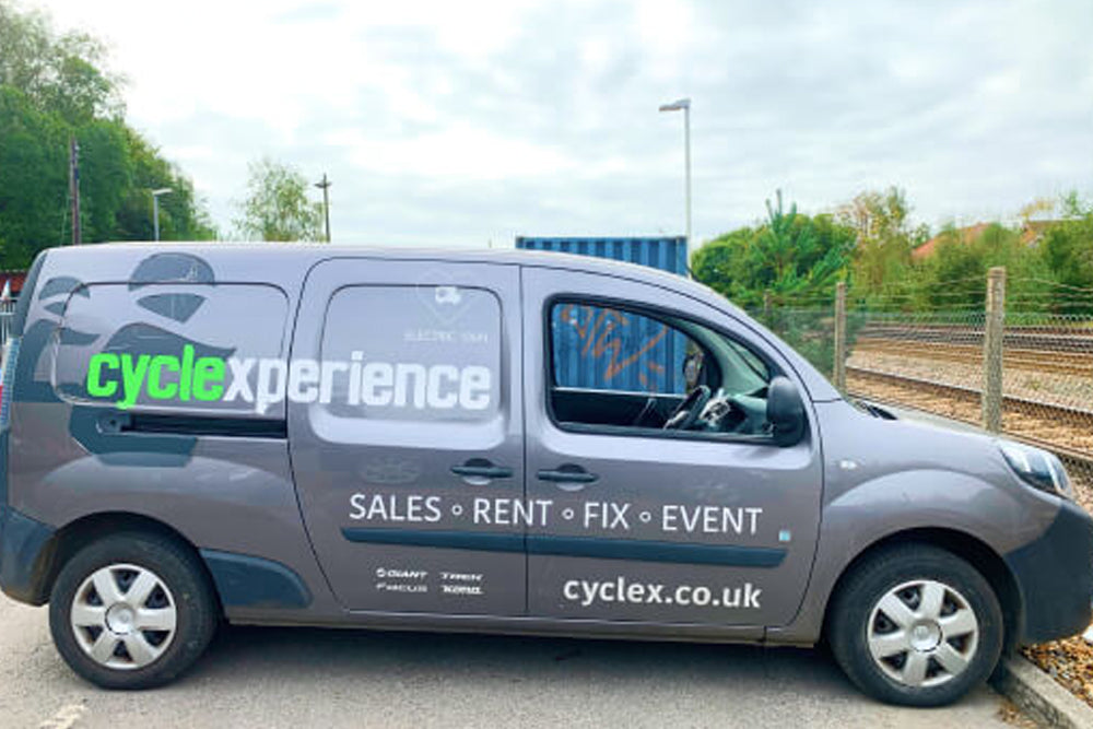 Grey van with Cyclexperience logo and the text 'Sales - Rent - Fix - Event'