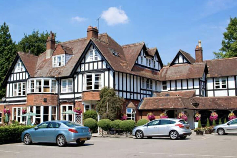 Image of a Tudor style building with hanging baskets